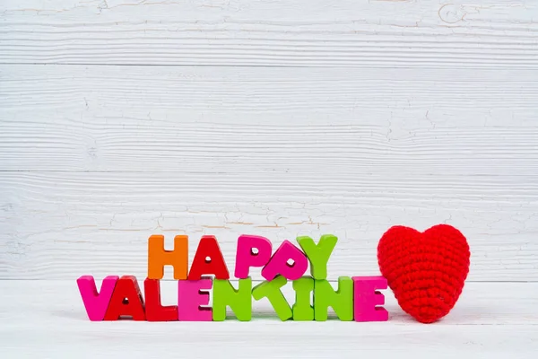 Valentine card with Happy valentine day text and red knitting he