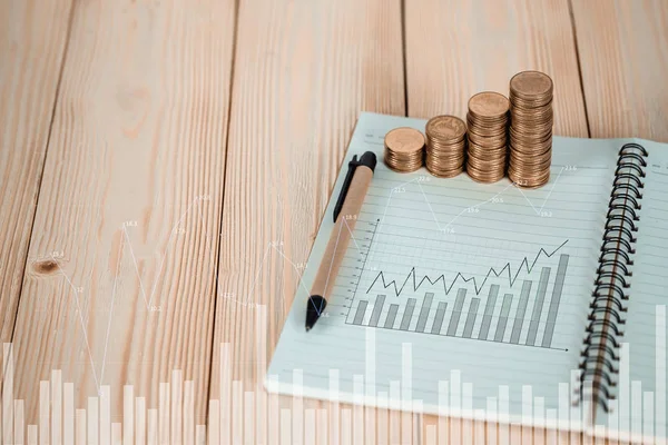 Steps of coins stack with notebook paper on wooden working table with copy space for text, financial and business planning concept idea. vintage tone.