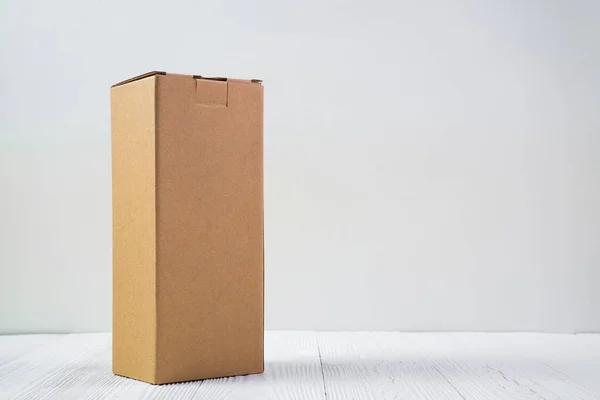 Empty Package brown cardboard box or tray on bright wooden table — Stock Photo, Image