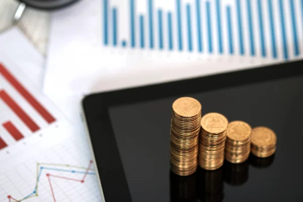 Passo de pilhas de moedas e tablet computador com gráfico financeiro, b — Fotografia de Stock