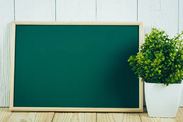 Blank green chalkborad with wood frame and little decorative tre — Stock Photo, Image