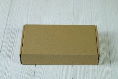 Boş paket kahverengi karton kutu veya parlak ahşap masa üstünde tepsi