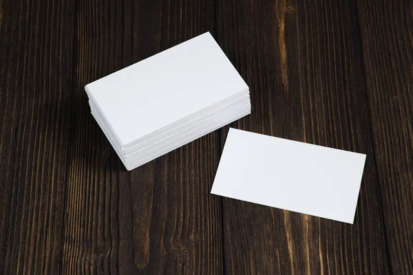 Blank business cards on wooden working table with copy space for