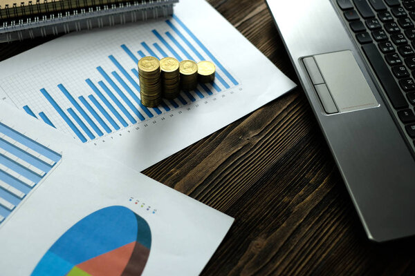 Step of coins stacks with notebook laptop computer and financial