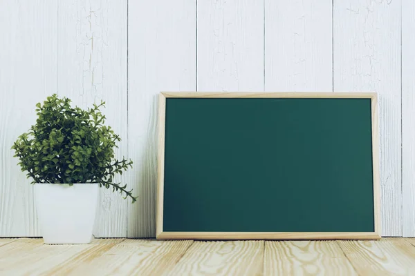 Blank green chalkborad with wood frame and little decorative tre — Stock Photo, Image