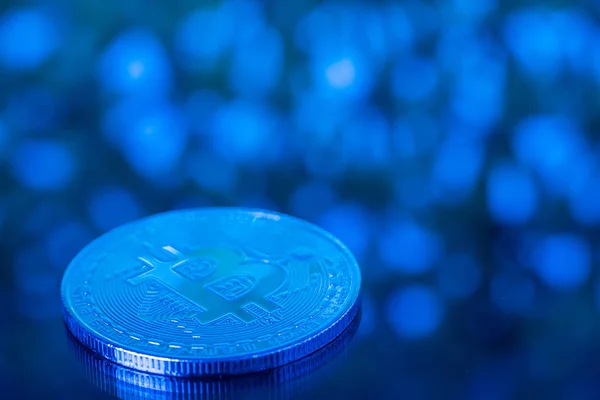 Bitcoin digital currency,  bit-coin on blue blurred bokeh backgr