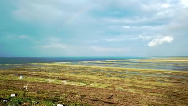 海の上の二重虹の空中ビュー 海と島の上の虹の空中ビュー 虹とDzharylgach島の空中ビュー 島の湖の空中ビューと二重虹 — ストック動画