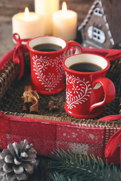 Cups of coffee and cinnamon sticks, burning candles and  pine co — Stock Photo, Image