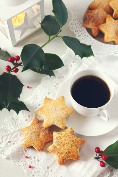 Christmas cookies, coffee, holly and  burning lantern — Stock Photo, Image