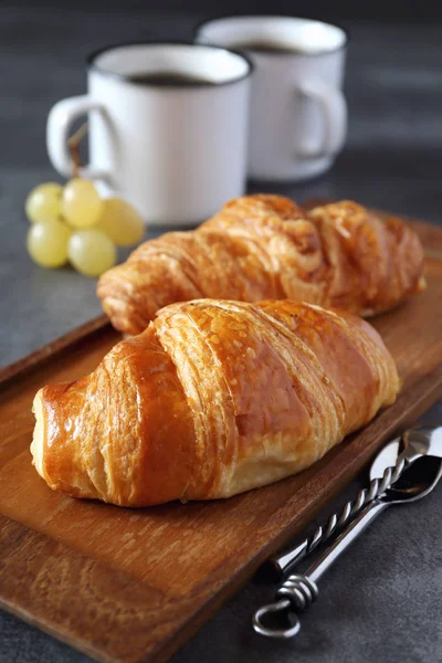 Two fresh croissants and cups of coffee — Stock Photo, Image