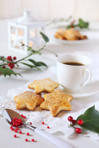 Christmas cookies, cup of coffee, holly and white lantern — Stock Photo, Image