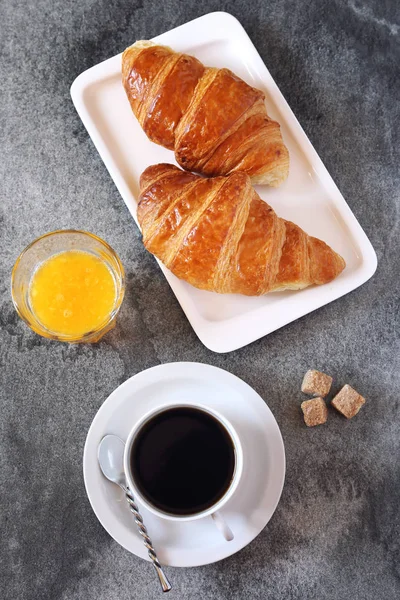 Two fresh croissants, orange juice and cup of coffee for breakfa — Stock Photo, Image