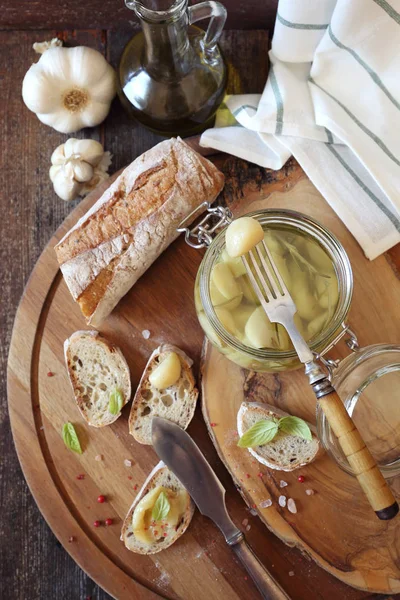 Appetizer: garlic confit in jar and franch spread bread — Stock Photo, Image