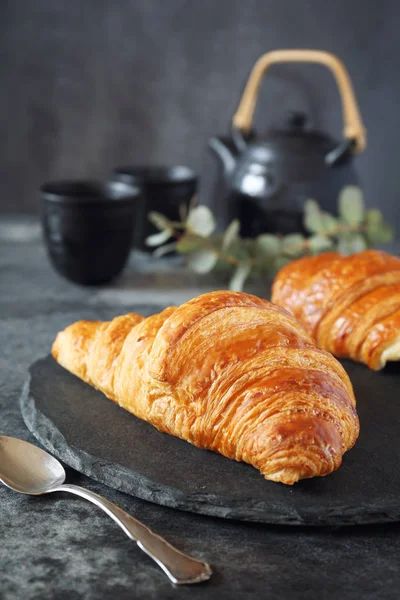 Two fresh croissants and teapot — Stock Photo, Image