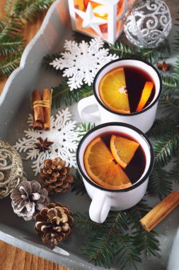 Mulled wine with spices and citrus fruit and burnind lantern clipart
