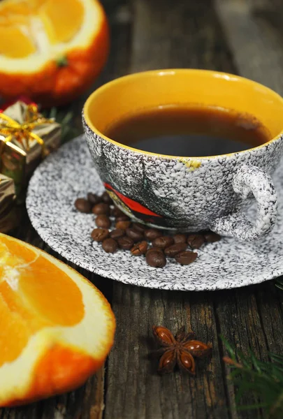 Cup of coffee, orange and Christmas-tree decorations — Stock Photo, Image