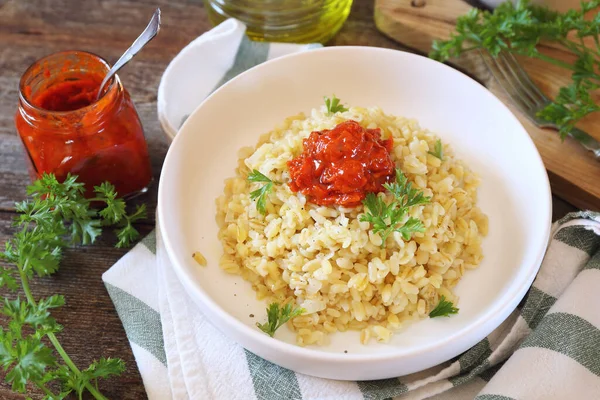 Pearl barley with tomato sauce and grated parmesan cheese — Stock Photo, Image