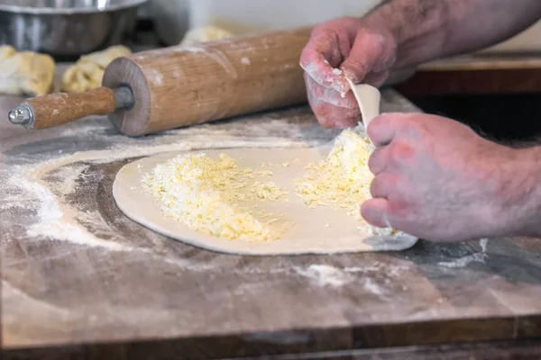 Hand made Georgian dough for food called khachapuri on wood plate, Minsk, Belarus.