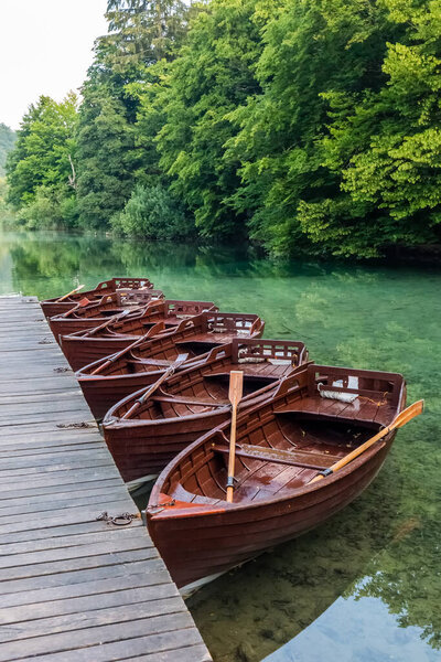 Wooden boats near waterfalls of one of the most astonishing places in the world at  Plitvice Lakes, Croatia. A truly virgin and wonderful piece of nature.