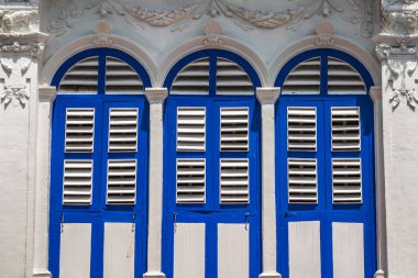 Pencerelerdeki ahşap panjurlar farklı şekillerde. Tayland 'ın eski Phuket kasabasındaki renkli binalar. Sino Portekiz tarzı.