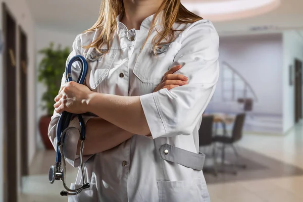Healthcare and medical concept. Medicine female doctor with stethoscope in hand at the hospital.