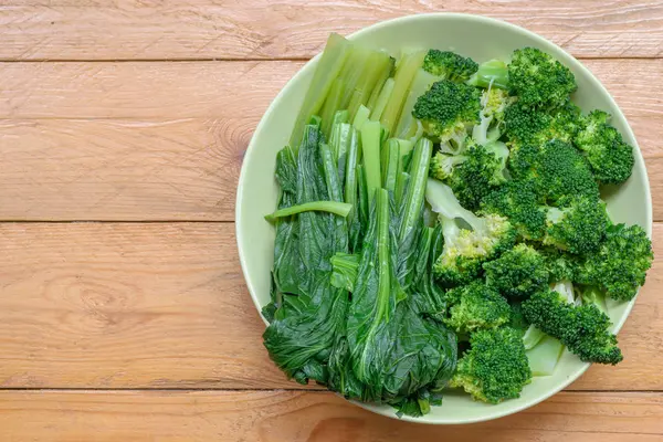 Broccoli and Bok choy on wood table background. — Stock Photo, Image