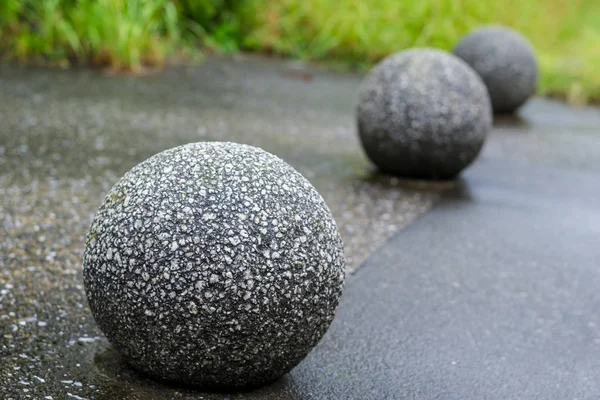 Close up of Rock like a ball Decorated in a Japanese garden.