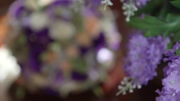 Wedding rings lie on a wedding bouquet — Stock Video