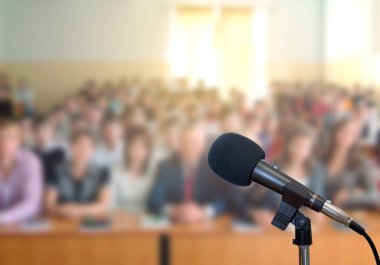 Sahnede oditoryumun arka planına karşı mikrofon