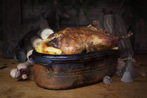 Christmas Duck Roast At The Wooden Table With Wood Logs and Pine Branches In The Background — Stock Photo, Image