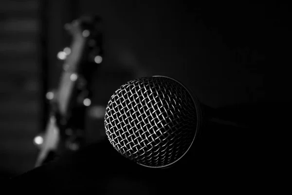 Microphone Close up with Bass Guitar In The Background — стоковое фото