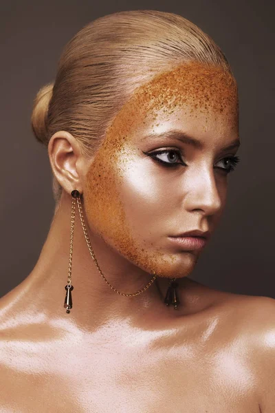 beautiful woman with tan and spices on face