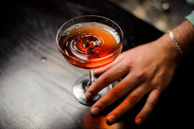 kırmızı bir martini cam içine kokteyl ile profesyonel barmen