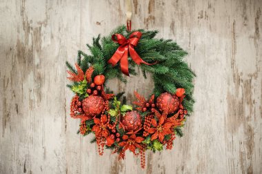 Advent Christmas wreath on wooden door decoration clipart
