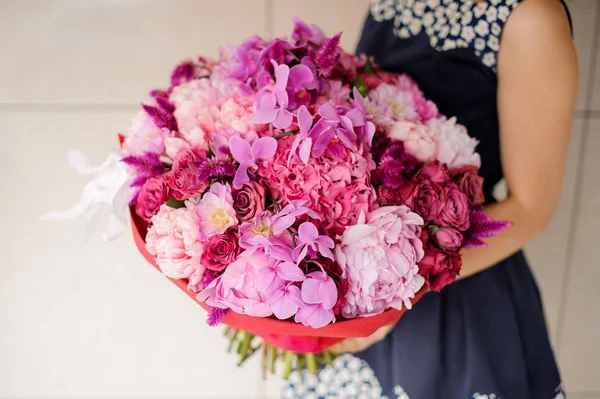 Bright and beautiful bouquet of colorful flowers in hands — Stock Photo, Image