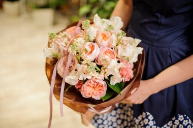 Güzel bir tutan kadın ve yumuşak çiçek kompozisyon