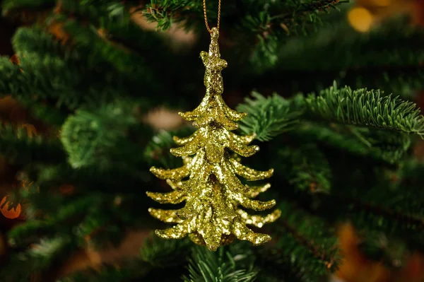 Golden Christmas tree decoration toy in the form of little fir tree — Stock Photo, Image