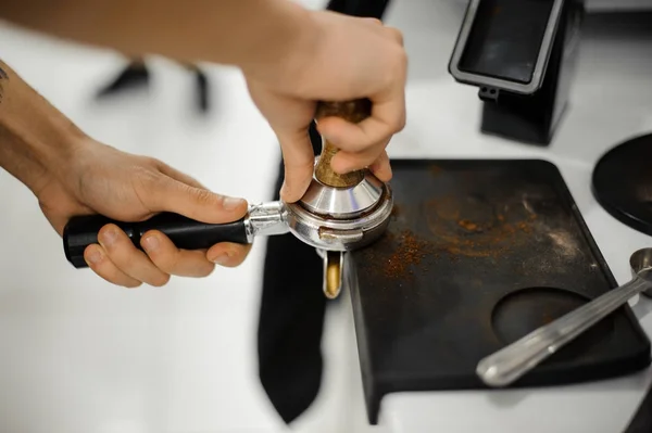 Barista making a coffee tablet with help of temper — Stock Photo, Image