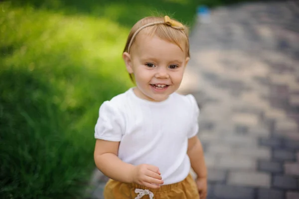 Leende liten blond flicka med söta pannband — Stockfoto