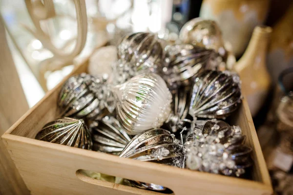 Стеклянные игрушки для украшения елки в виде серебряных шариков в деревянной коробке — стоковое фото