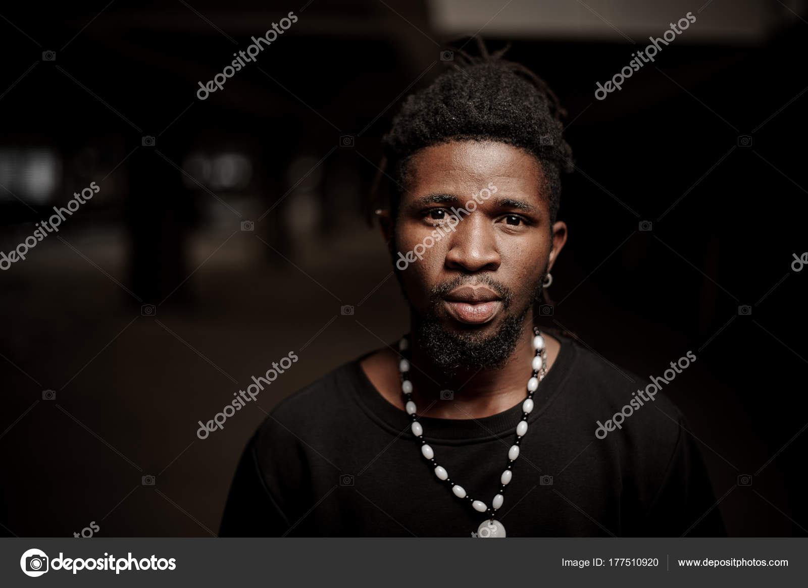 African American Guy In Black Clothes Wearing Dreadlocks And