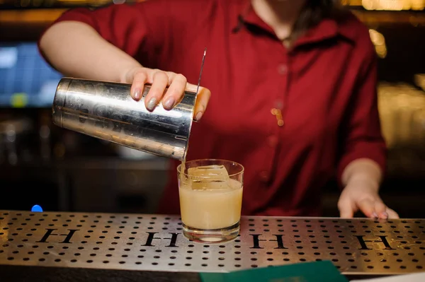 Mulher barman derramando um coquetel fresco no copo — Fotografia de Stock