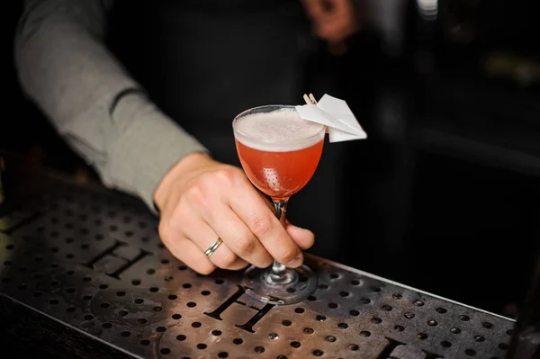 Barmann hält ein dekoriertes Cocktailglas in der Hand — Stockfoto