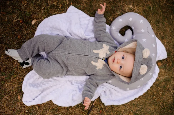 Bebê bonito vestido de romper com capuz deitado no travesseiro — Fotografia de Stock