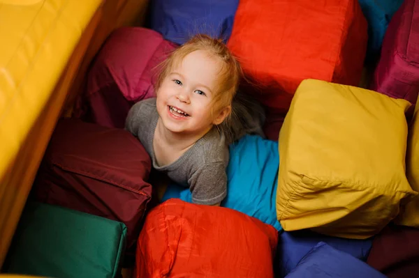 Linda niña sonriente jugando en la sala de juegos — Foto de Stock