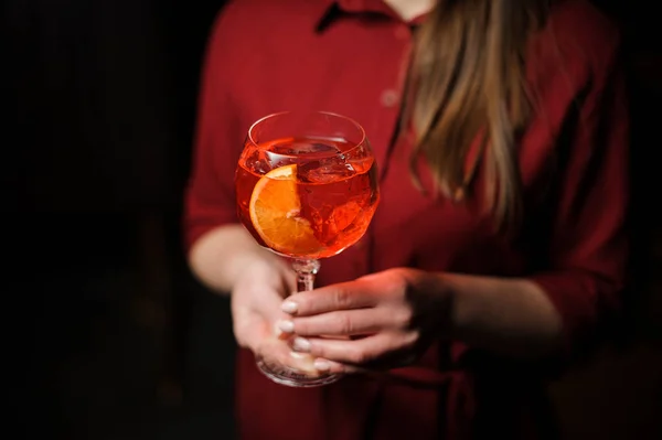 Woman dressed in a red shirt with a tasty Aperol syringe summer cocktail — Stock Photo, Image