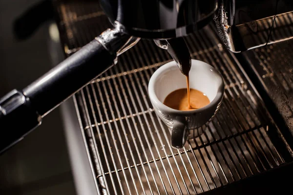 White ceramic cup of espresso in the coffee mahine