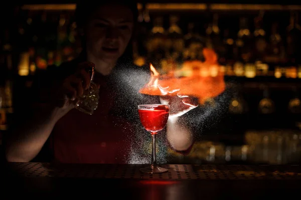 Vrouwelijke bartender spuiten op de brand wedstrijd boven de cocktail ik — Stockfoto