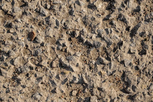 Närbild konsistens av bakgrunden tapeten ovanifrån grå säd asfalt — Stockfoto