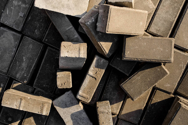 Close up texture background of randomly scattered grey building bricks